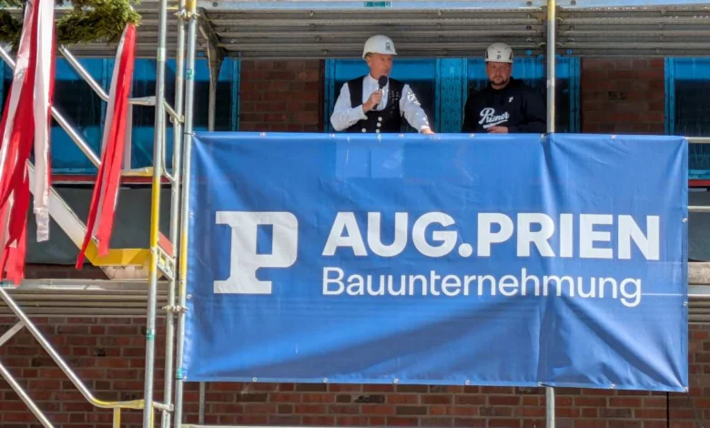two men standing on a scaffolding