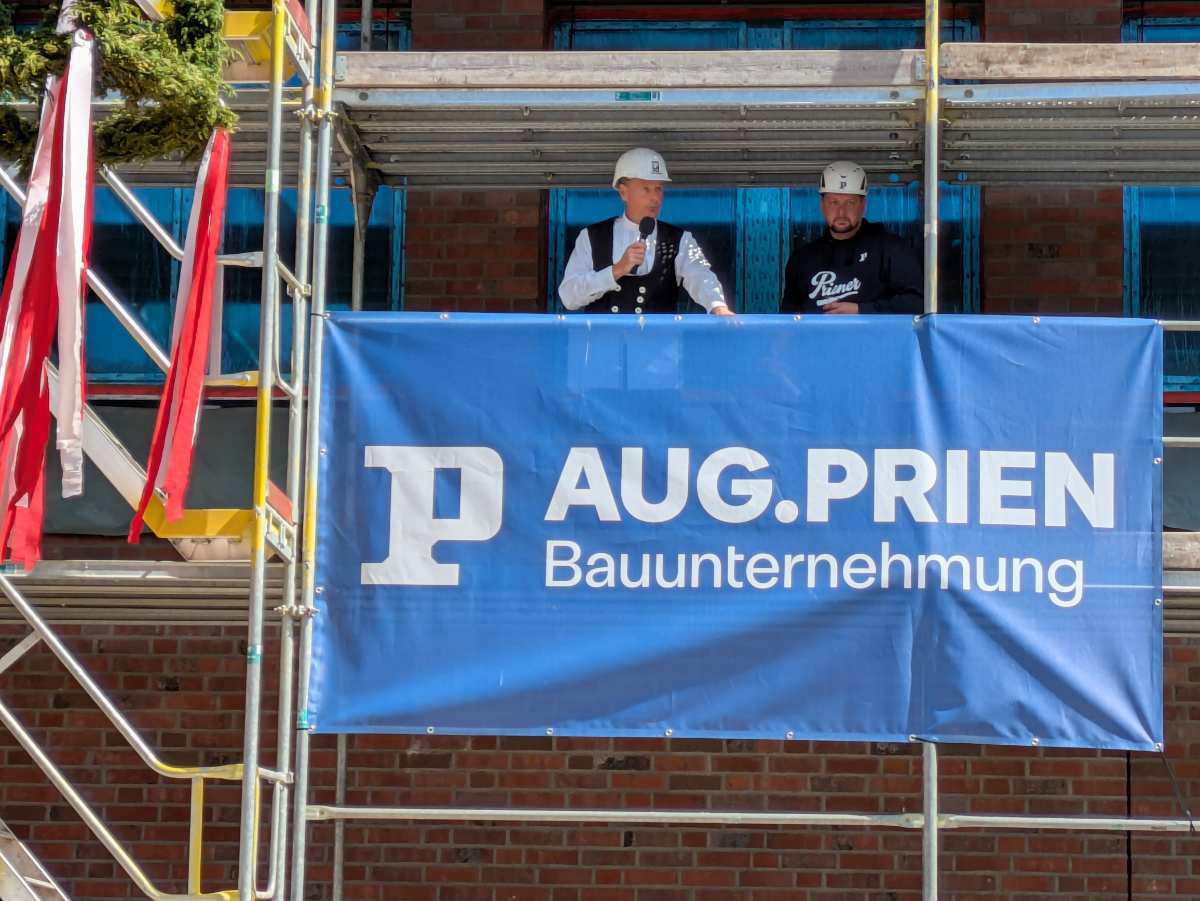two men standing on a scaffolding