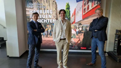 a group of men standing in front of a poster