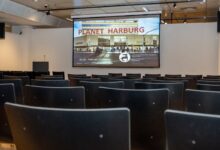 a room with chairs and a screen