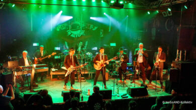 a group of people on a stage playing instruments