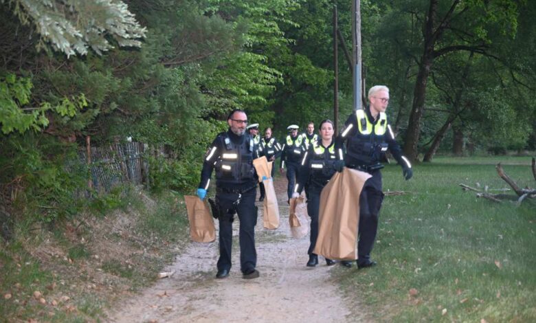 a group of police officers carrying bags