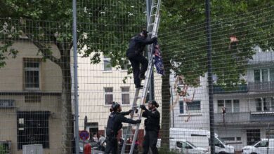 a group of men climbing a ladder