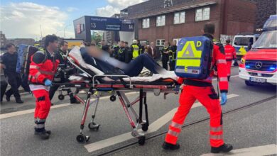 a group of people in uniform carrying a person on a stretcher