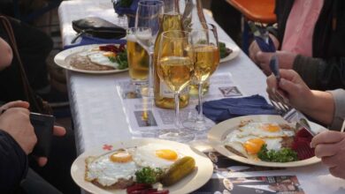 a table with plates of food and glasses of wine