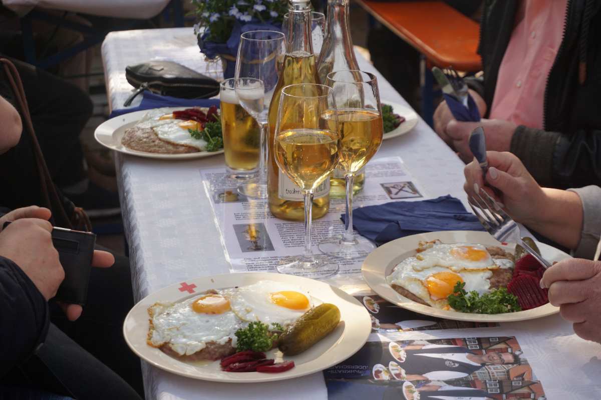 a table with plates of food and glasses of wine