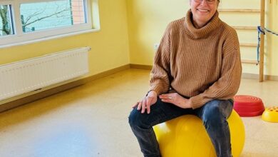 a woman sitting on a yellow ball