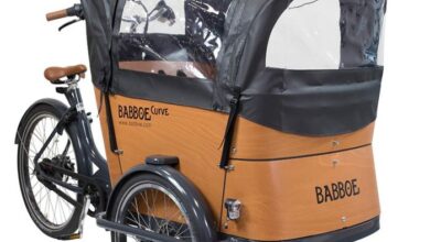 a bicycle with a covered trailer