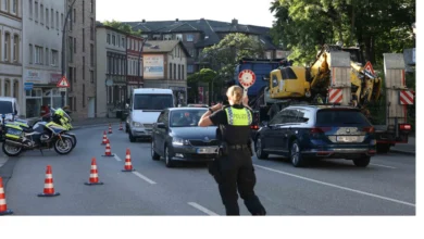 a police officer standing on a street with traffic cones