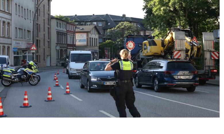 a police officer standing on a street with traffic cones