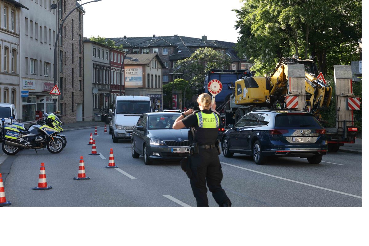 a police officer standing on a street with traffic cones