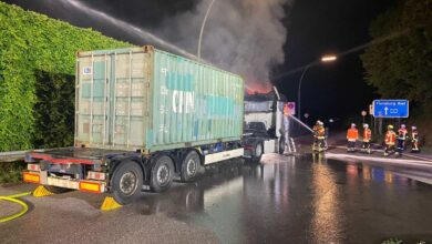 a firemen spraying water on a truck