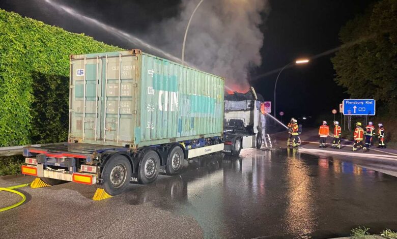 a firemen spraying water on a truck