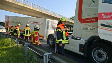 a group of people in safety gear standing next to a truck