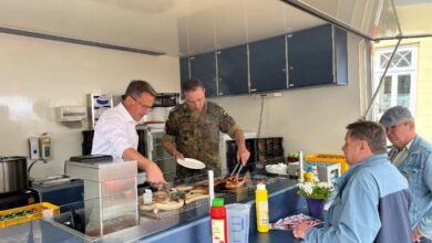 a group of men cooking in a kitchen