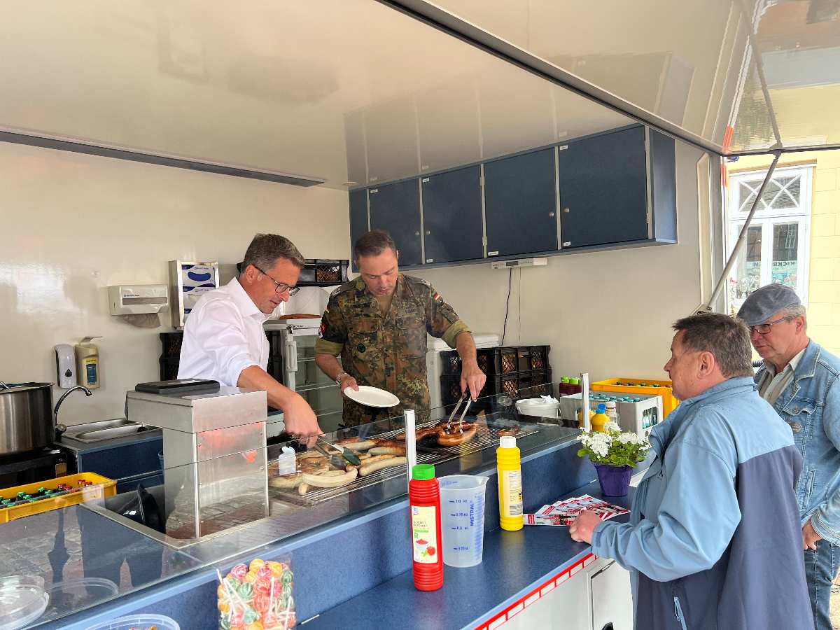a group of men cooking in a kitchen