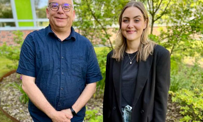 a man and woman standing in a yard