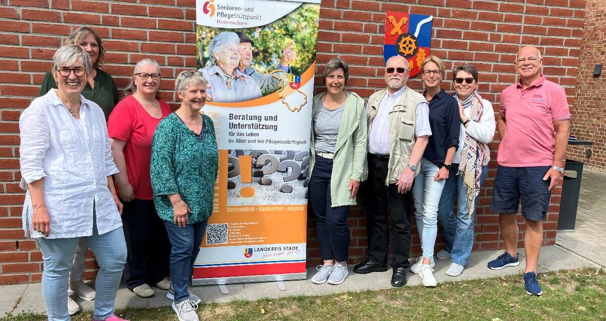 a group of people standing in front of a brick wall