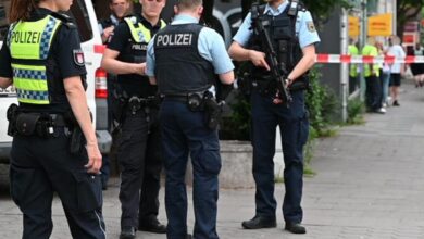 a group of police officers standing on a sidewalk