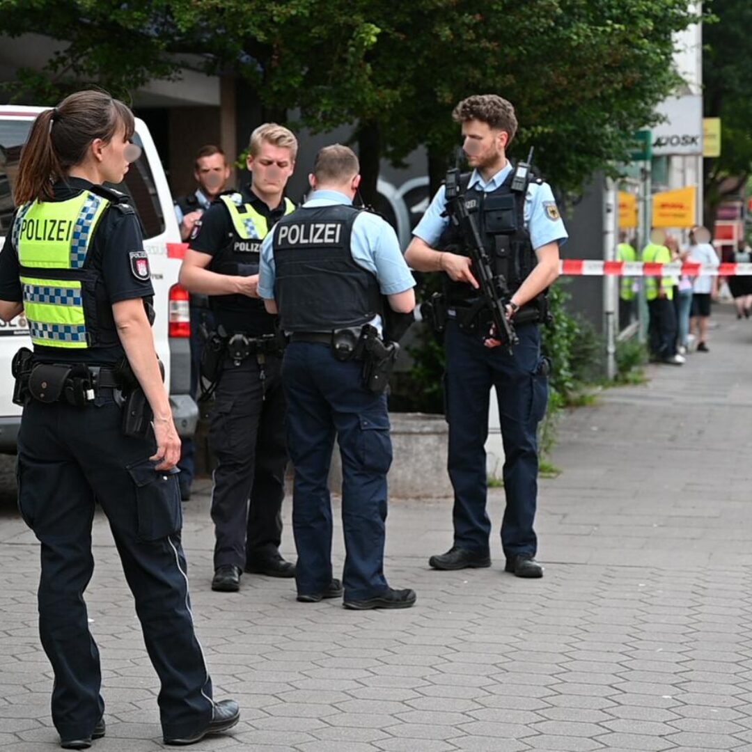 a group of police officers standing on a sidewalk
