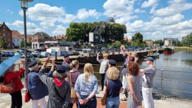 a group of people standing on a dock