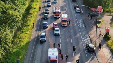 a road with cars and emergency vehicles