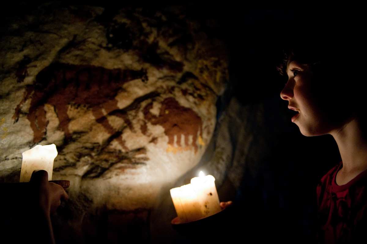 a child looking at a candle