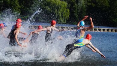 a group of people in swim caps swimming in water