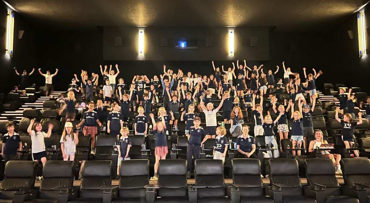 a group of people standing in a theater