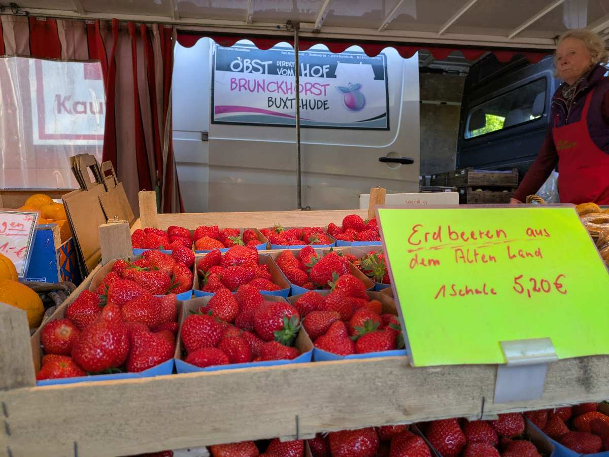 a box of strawberries in a market