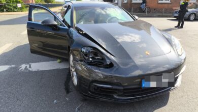 a black sports car with a broken headlight