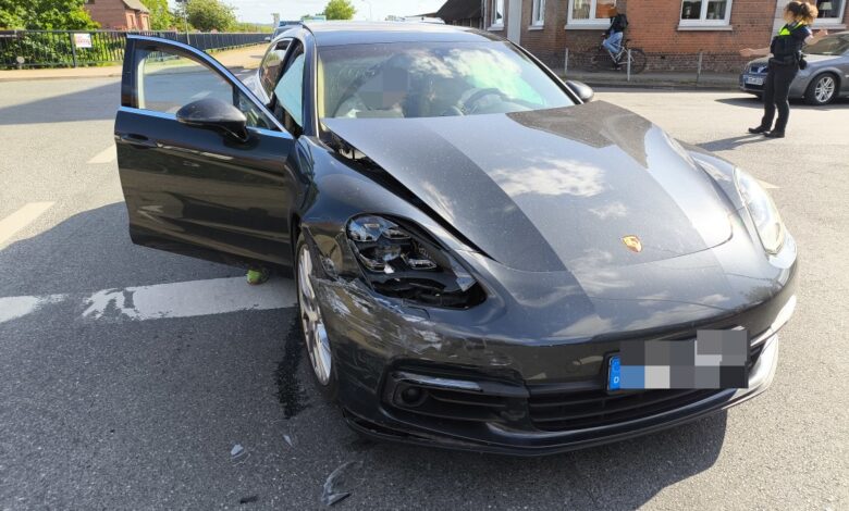 a black sports car with a broken headlight