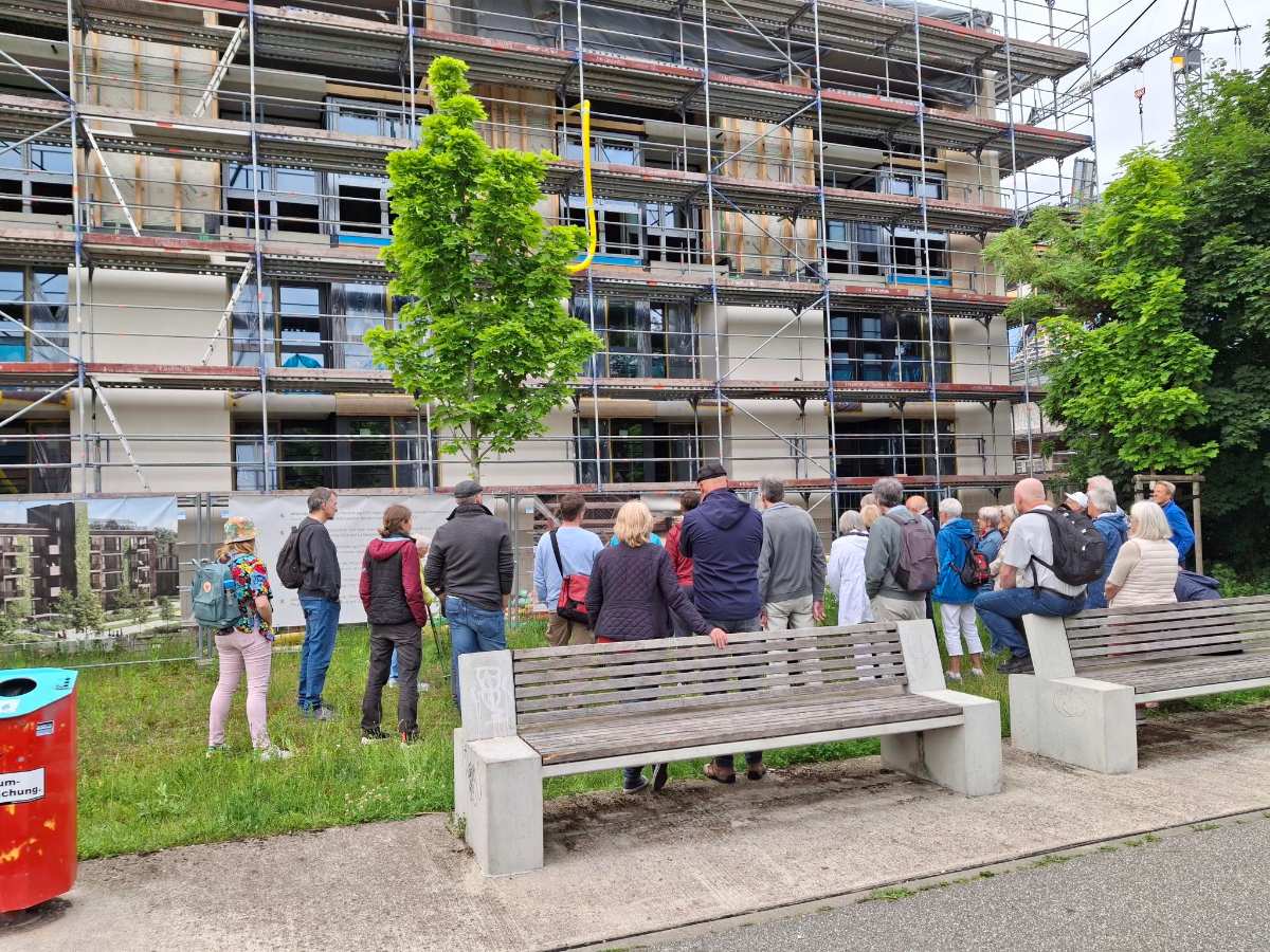 a group of people standing on a bench in front of a building