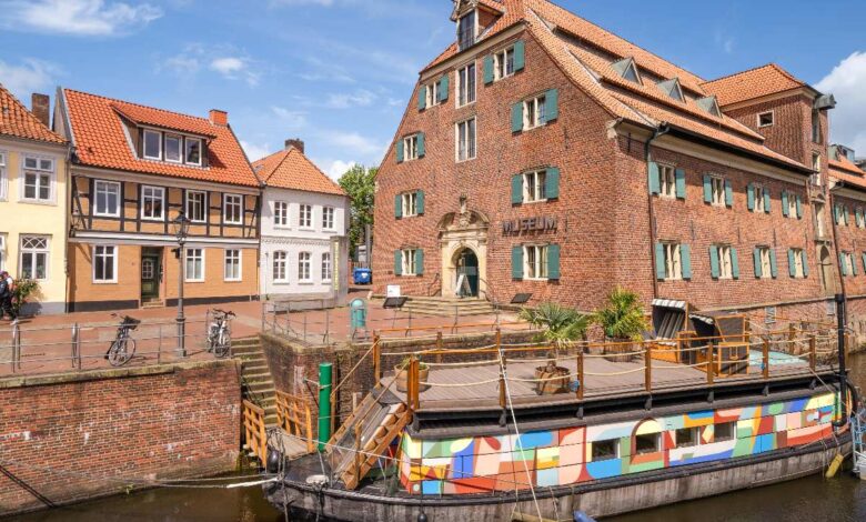 a boat on a canal next to a building