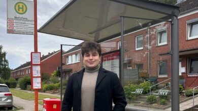 a man standing under a bus stop