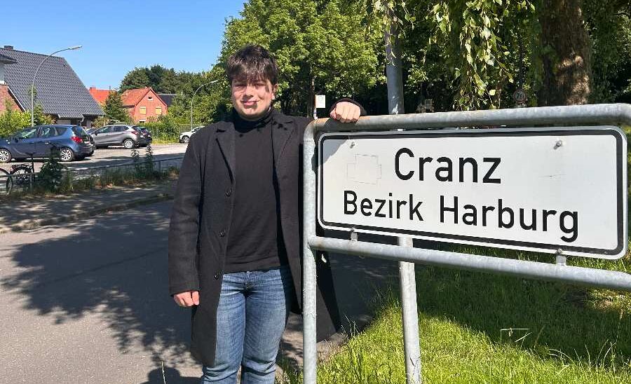 a man standing next to a sign