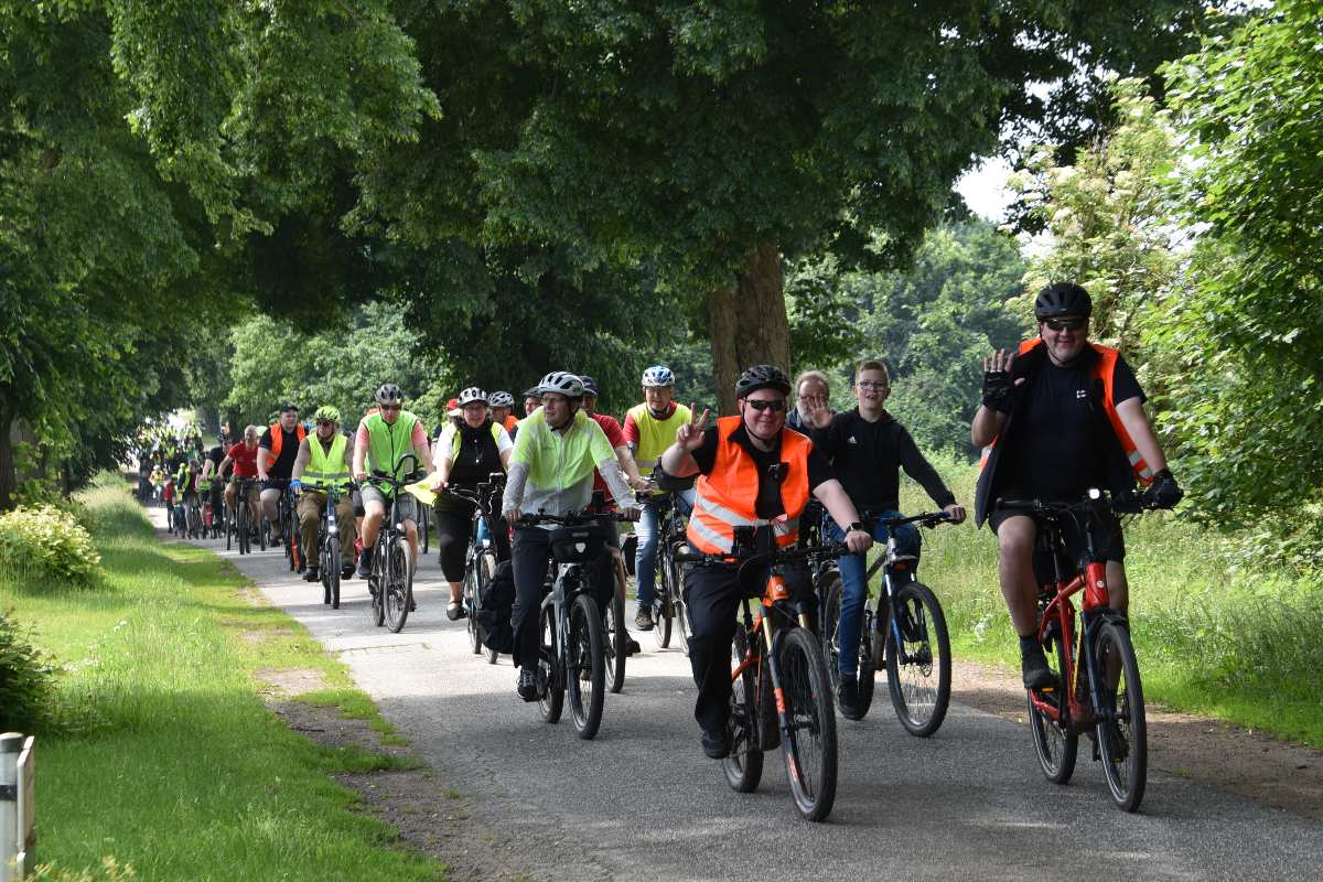 a group of people riding bicycles on a path