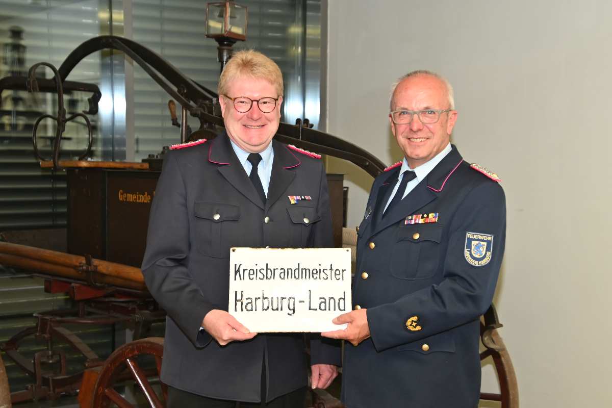 two men in military uniforms holding a sign