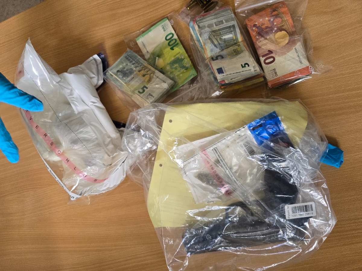 a bag of money and a gun on a table