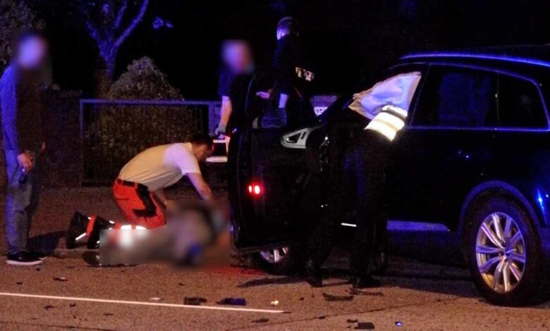 a group of people looking at a car