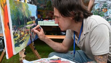 a man painting on a canvas