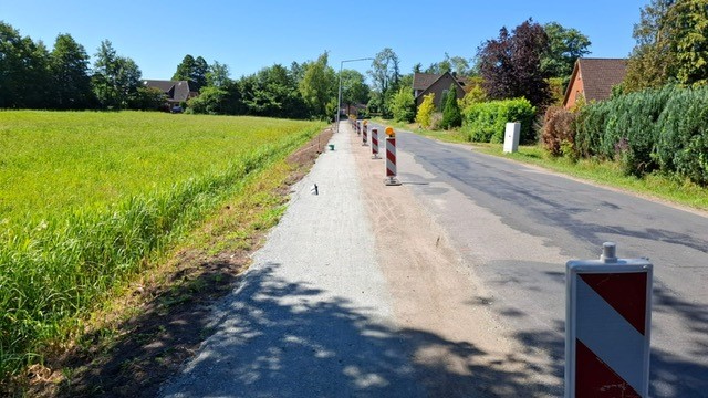 a road with a row of construction signs
