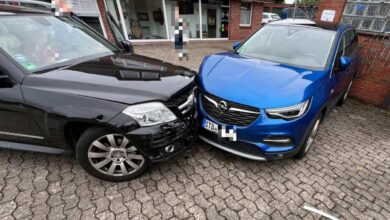 a black car with a black front end and a blue car with a black front end