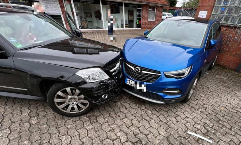 a black car with a black front end and a blue car with a black front end