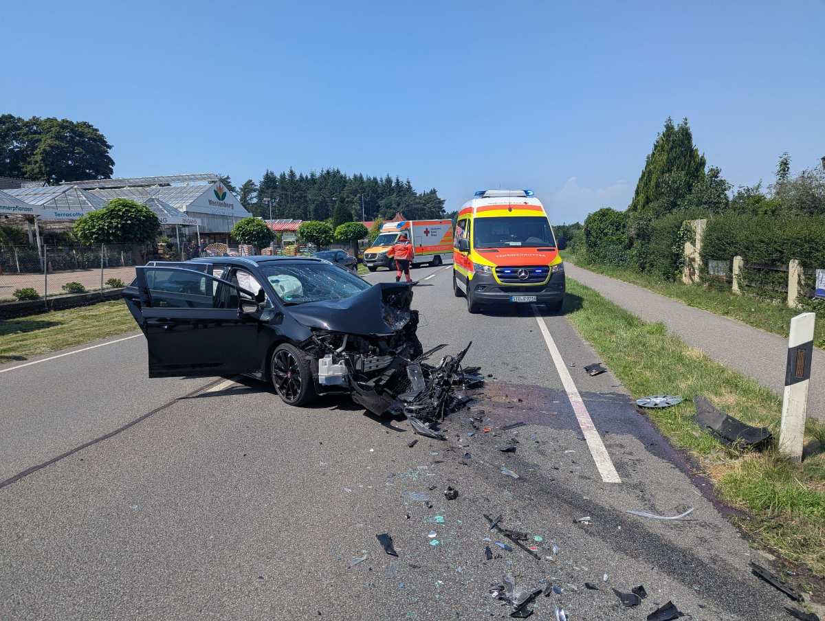 a car crashed into a road with ambulances