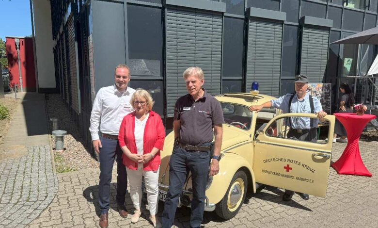 a group of people standing in front of a yellow car