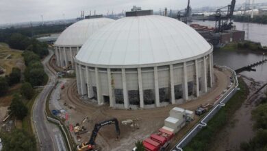a large round building with a circular structure in the background