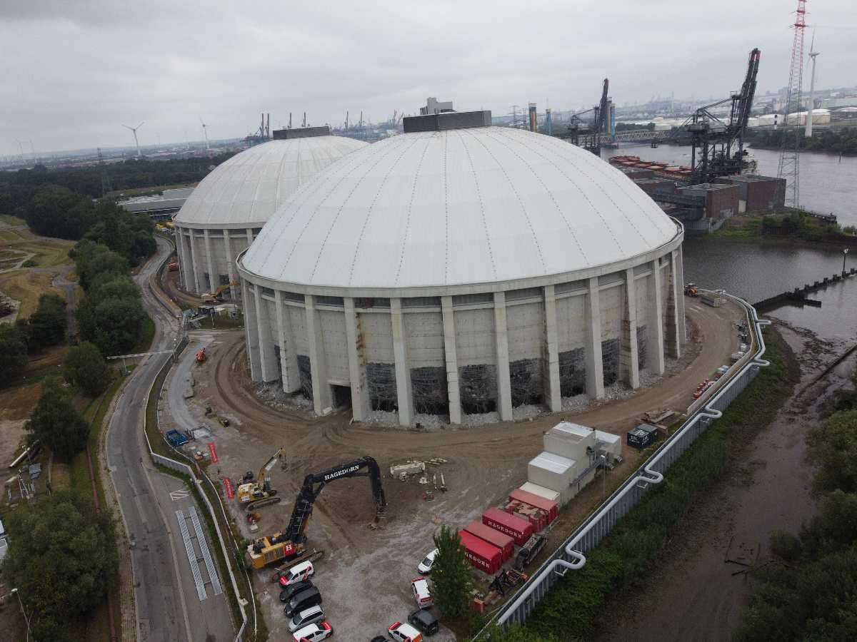 a large round building with a circular structure in the background