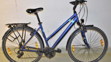 a blue bicycle against a white wall