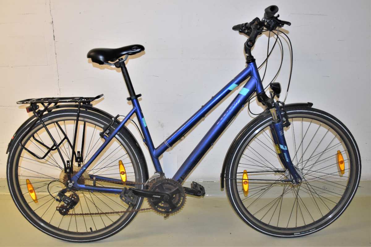 a blue bicycle against a white wall